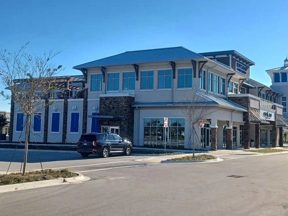 Two-story mixed-use building with storefront glass