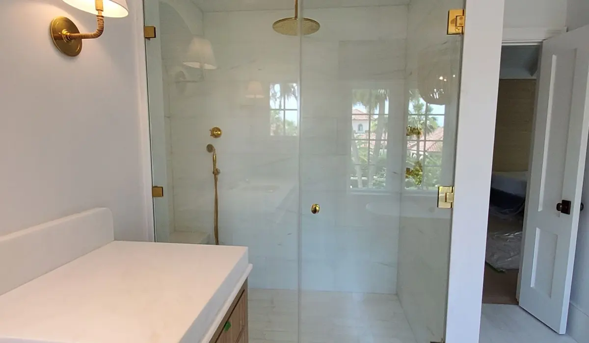 Frameless glass shower with brass hardware