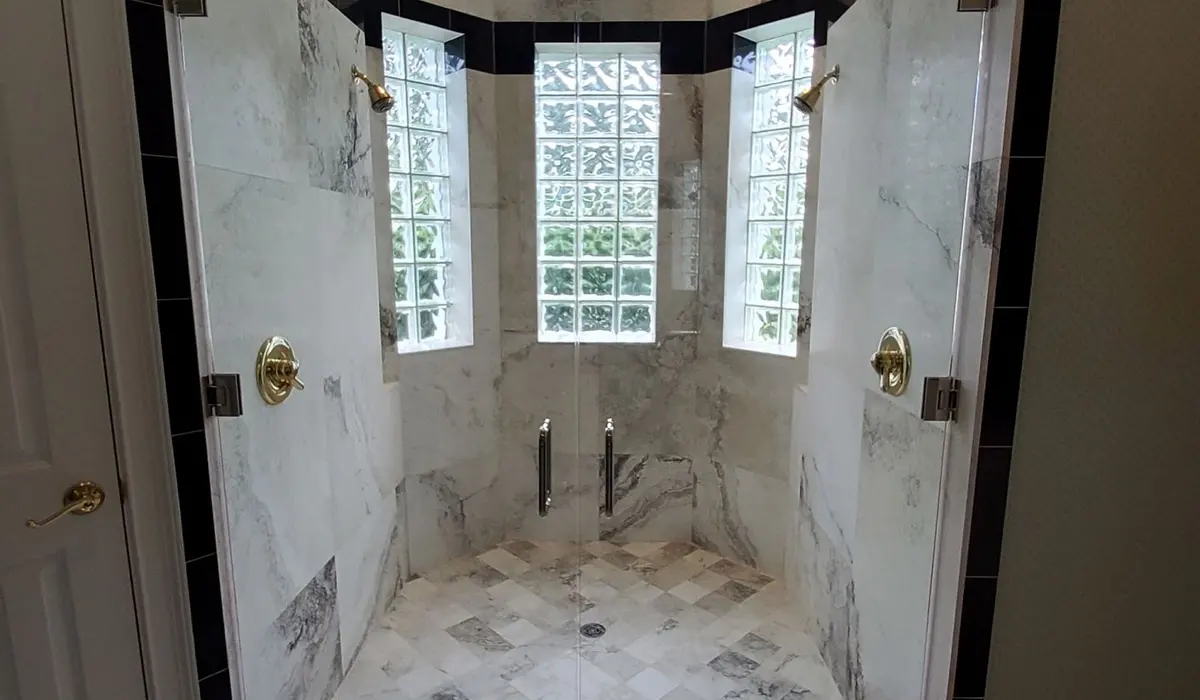 Custom frameless steam shower with a glass block window
